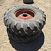Pair of 14.9 24 tires on case 8 bolt wheels