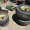 Set of 4 turf tires on rim from John Deere 4700 compact